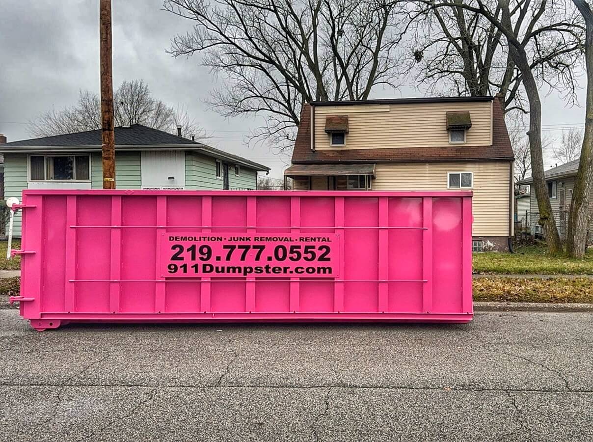 Vibrant pink 911 Dumpster in North West Indiana ready for rental